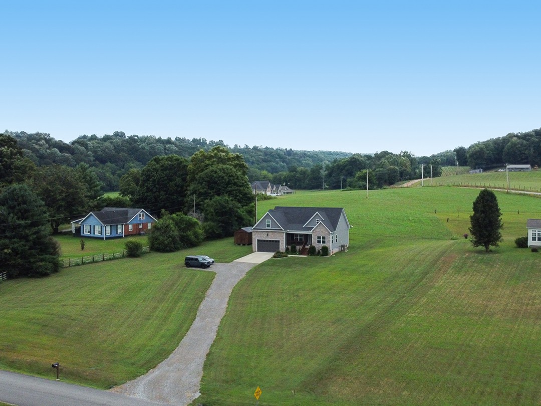124 Piney Road Dickson, TN 37055 - Photo 8 of 39 a view of a lake with lawn chairs and a yard
