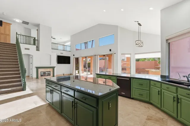 a kitchen with stainless steel appliances granite countertop a sink and a stove