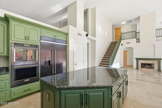 a kitchen with granite countertop a oven a refrigerator and a sink