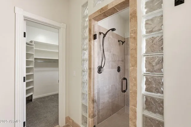 a bathroom with a glass shower door