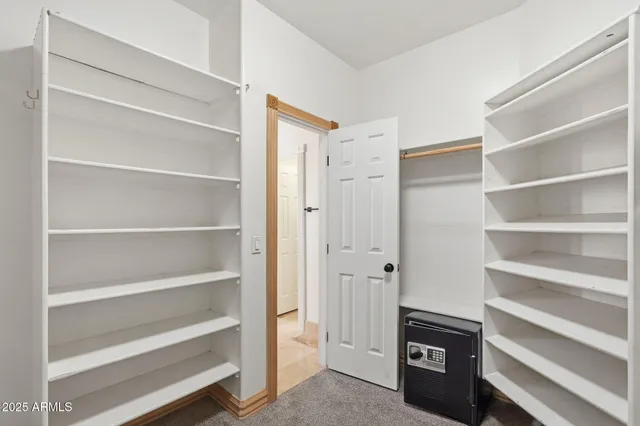 a view of walk in closet with empty racks