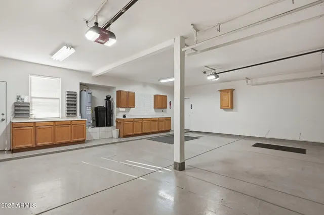 a spacious bedroom with a large bed and ceiling fan