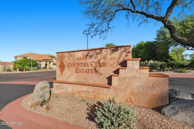 a white house with a tree in the background