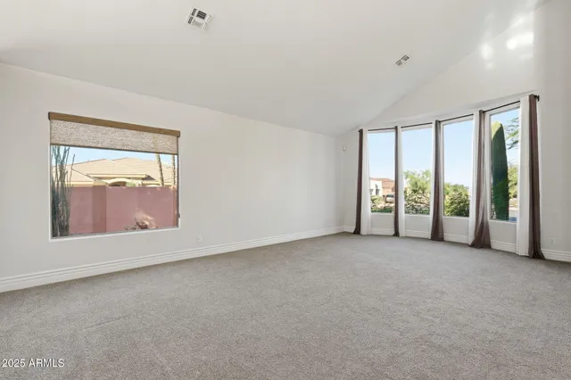 an empty room with windows and mountain view