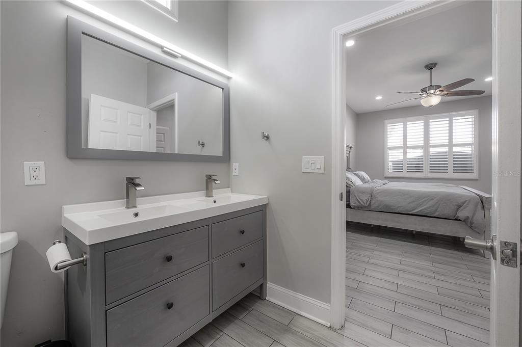 2341 West Chestnut Street Tampa, FL 33607 - Photo 19 of 42 a en suite bathroom with a toilet sink and mirror