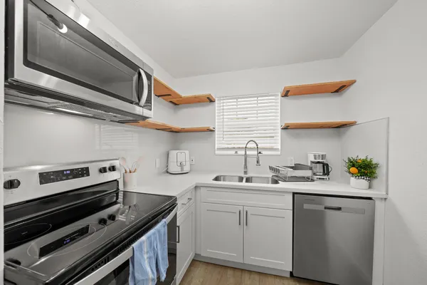 a kitchen with a sink cabinets and stainless steel appliances