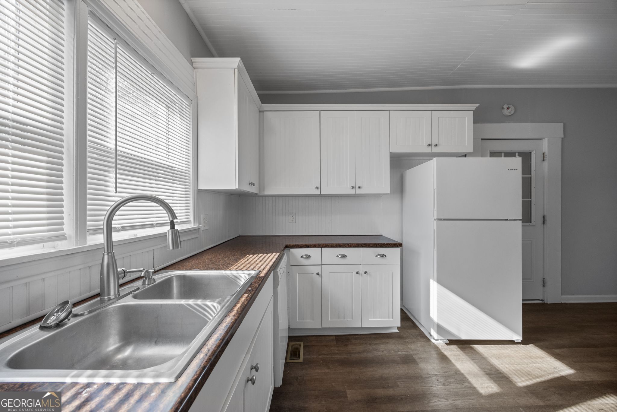 743 Pine Street Trion, GA 30753 - Photo 12 of 31 a kitchen with a refrigerator sink and white cabinets