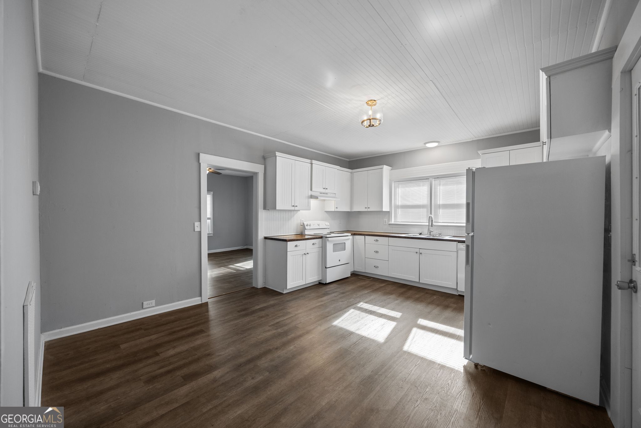 743 Pine Street Trion, GA 30753 - Photo 13 of 31 a view of a kitchen with a sink and dishwasher a refrigerator with wooden floor