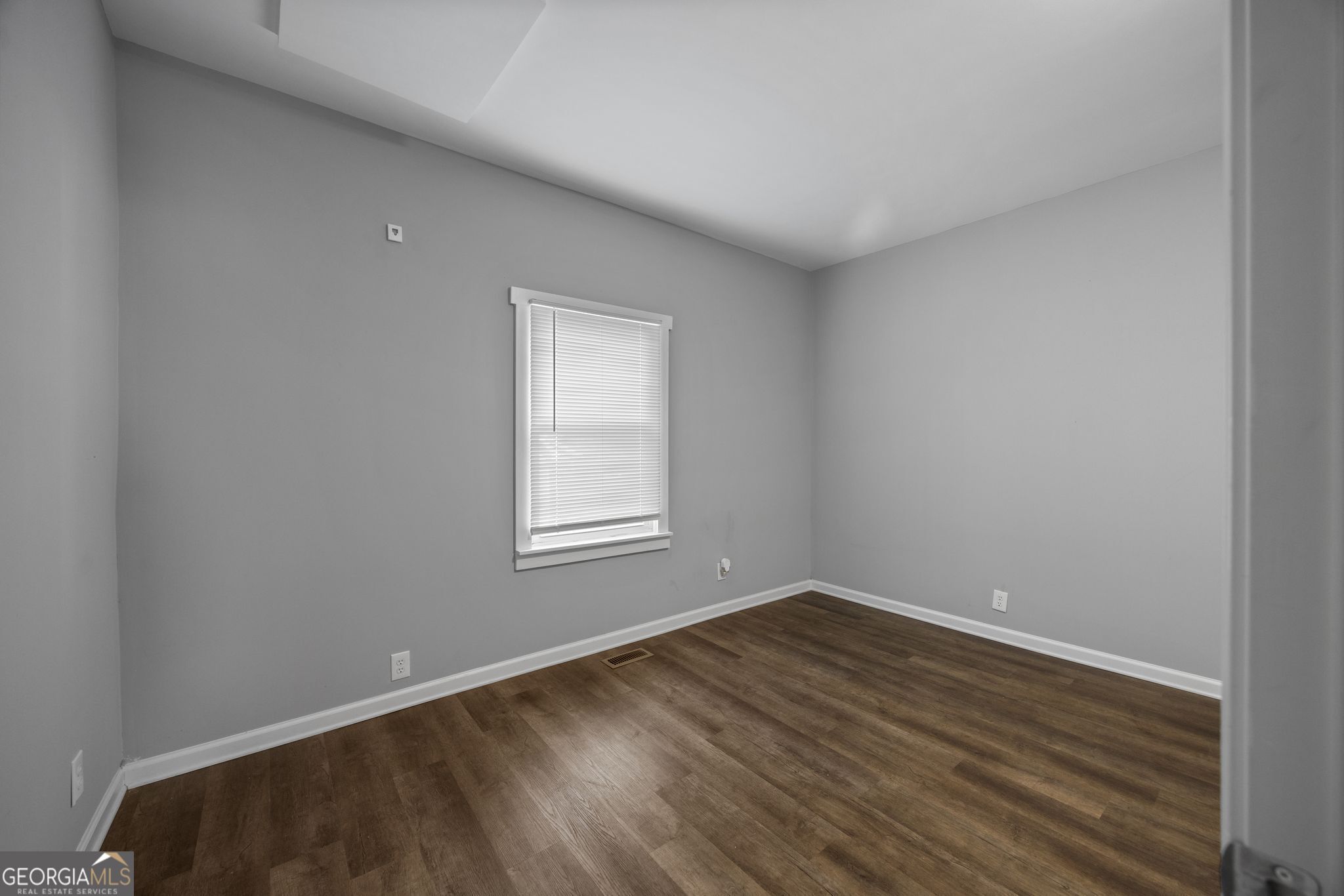 743 Pine Street Trion, GA 30753 - Photo 19 of 31 an empty room with wooden floor and windows