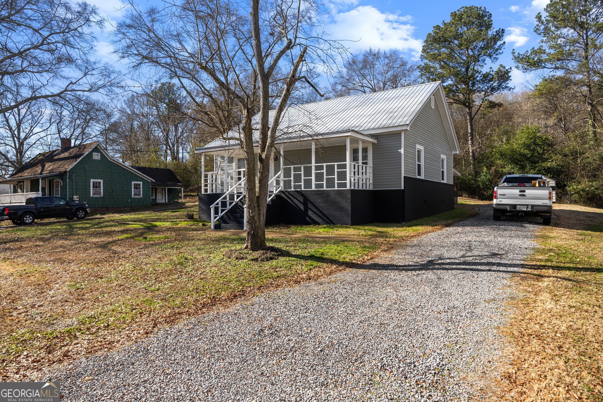 743 Pine Street Trion, GA 30753 - Photo 2 of 31 a view of a white house with a large tree next to a yard