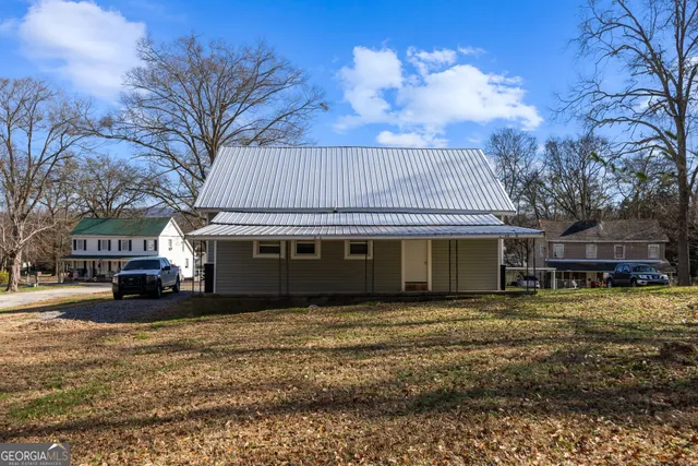 a house that has a tree in front of it