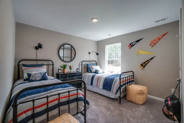 a bedroom with bed and a window