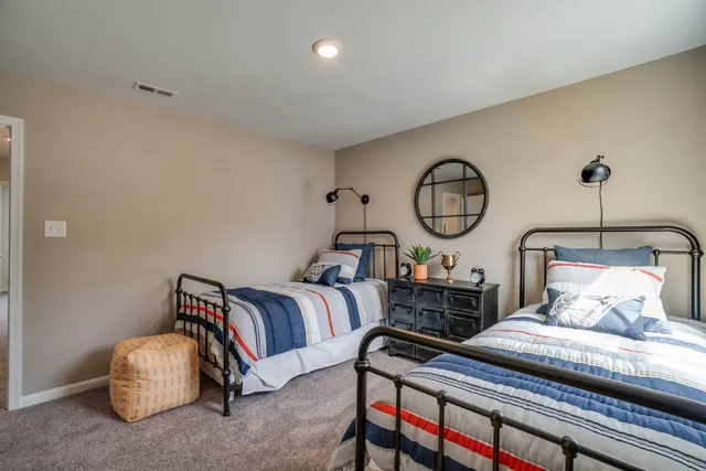 a bedroom with bed and a chandelier