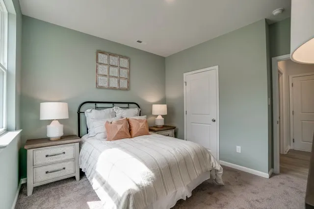 a bedroom with a bed and a lamp