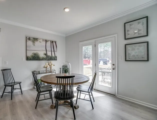 a view of a dining room with furniture and window