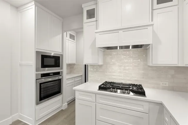 a white stove top oven sitting inside of a kitchen