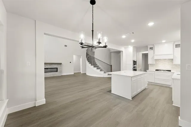 a view of kitchen with sink microwave and refrigerator