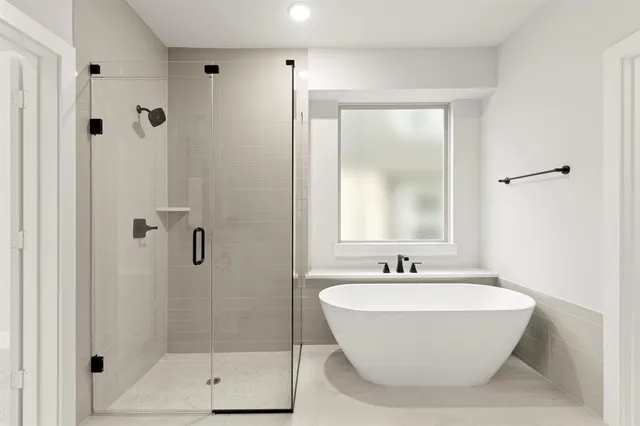 a bathroom with a bathtub and shower