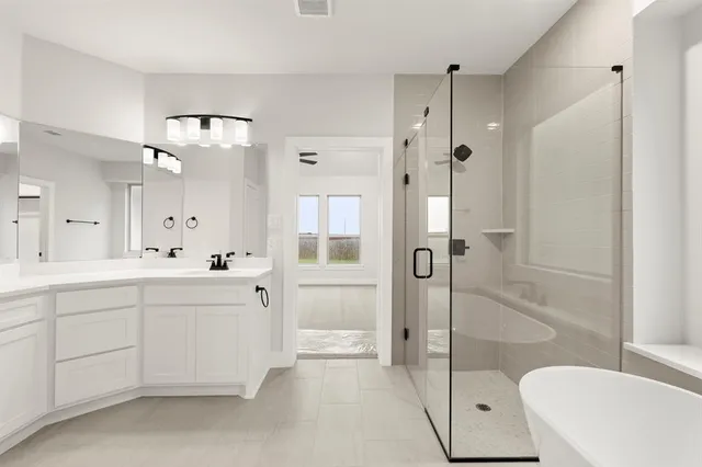 a spacious bathroom with a shower sink mirror and toilet