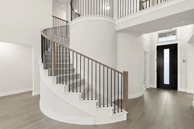 a view of staircase with white walls and a window