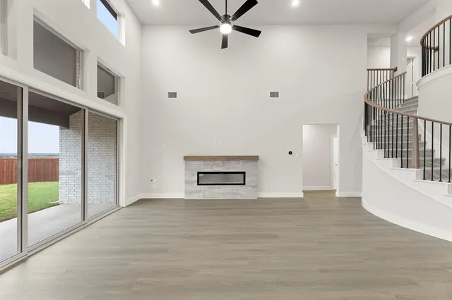 a view of an empty room with cabinet and stairs