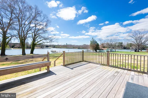 a view of a roof deck with wooden floor and fence