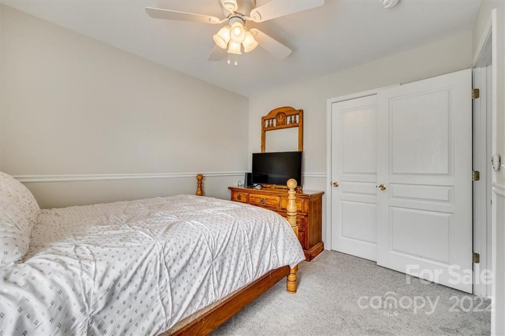 2337 Mirage Place Fort Mill, SC 29708 - Photo 23 of 43 a bedroom with a bed and a flat screen tv