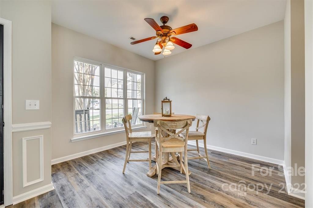 2337 Mirage Place Fort Mill, SC 29708 - Photo 7 of 43 a dining room with furniture a chandelier and wooden floor