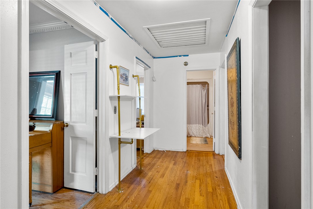 605 Sherry Drive Anderson, SC 29621 - Photo 17 of 36 Warm hardwood floors extend through this inviting hallway, guiding you to sunlit rooms.