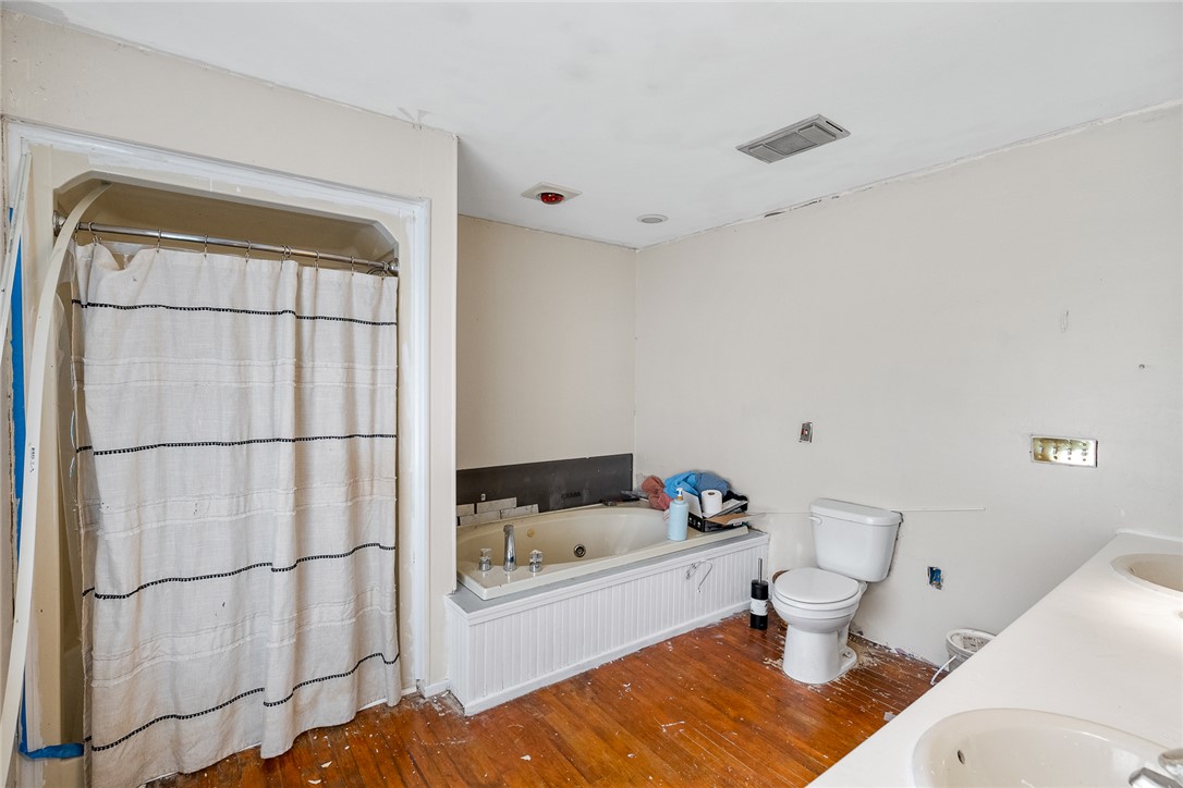605 Sherry Drive Anderson, SC 29621 - Photo 21 of 36 This bathroom features hardwood floors, a built-in tub, and a spacious vanity.