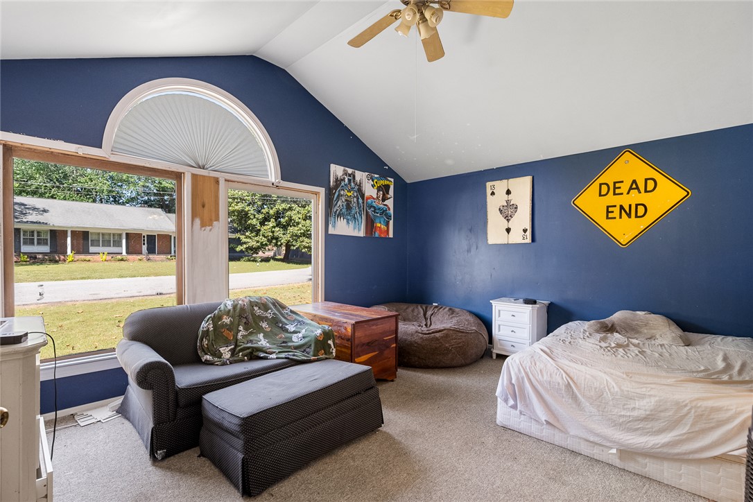 605 Sherry Drive Anderson, SC 29621 - Photo 24 of 36 This bright bedroom features a ceiling fan and expansive windows, offering abundant natural light and exterior views.