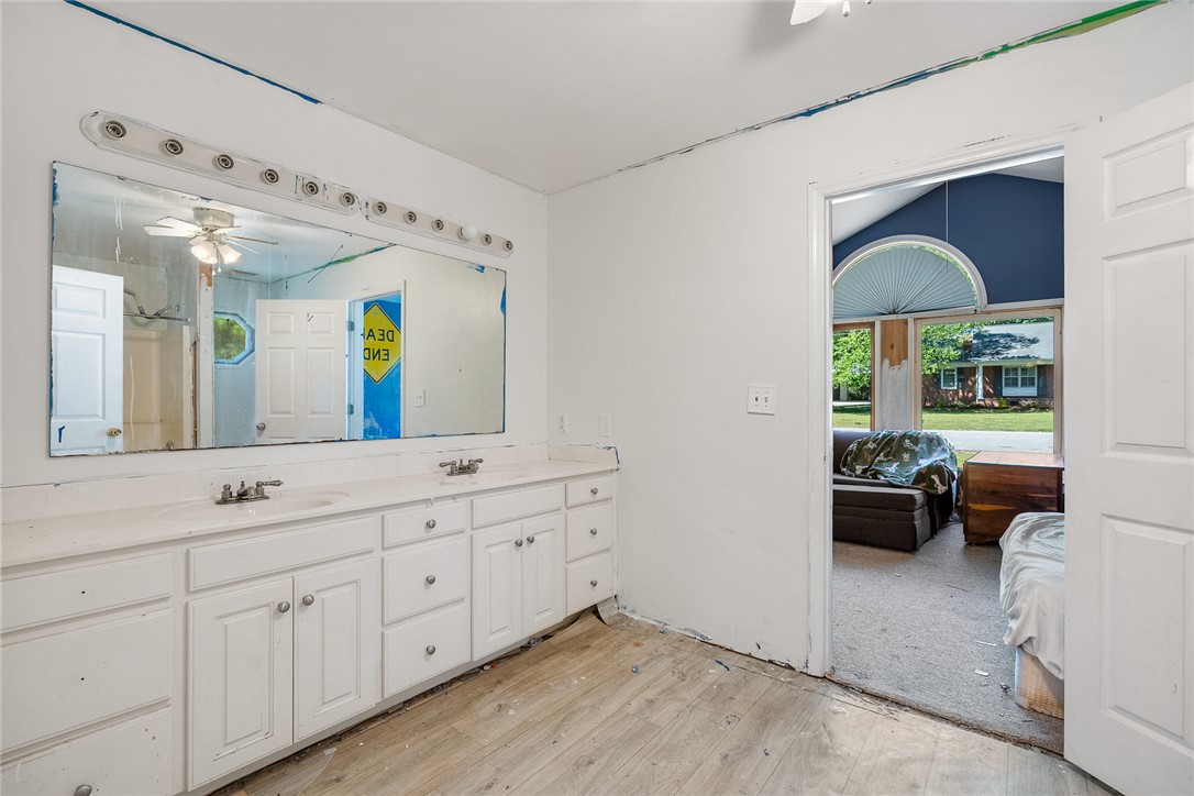 605 Sherry Drive Anderson, SC 29621 - Photo 25 of 36 This primary bathroom features a double vanity and a ceiling fan, offering practical comfort.