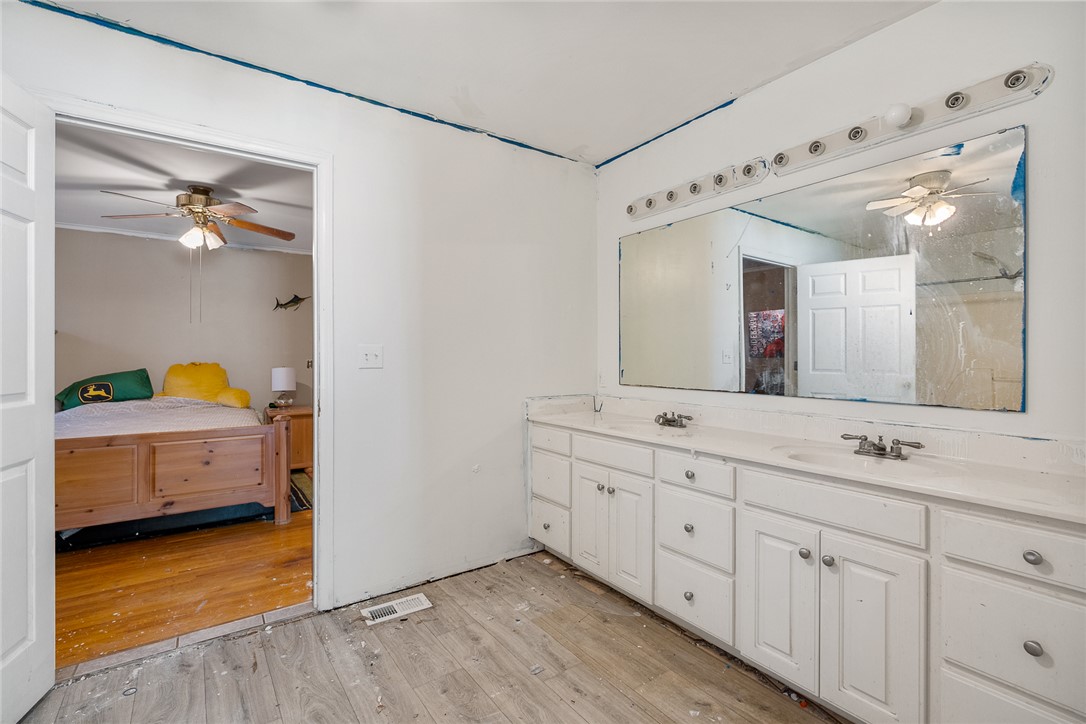 605 Sherry Drive Anderson, SC 29621 - Photo 26 of 36 This bathroom features a double vanity and an open doorway to an adjoining room.