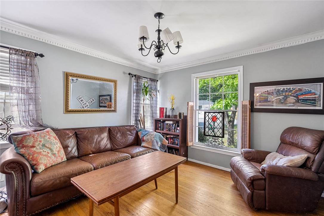 605 Sherry Drive Anderson, SC 29621 - Photo 8 of 36 This living room features rich wood flooring, crown molding, and a chandelier, perfect for entertaining.