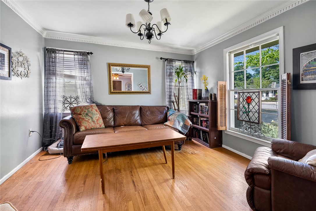 605 Sherry Drive Anderson, SC 29621 - Photo 9 of 36 This inviting living room features hardwood flooring, crown molding, and large windows that fill the space with natural light.