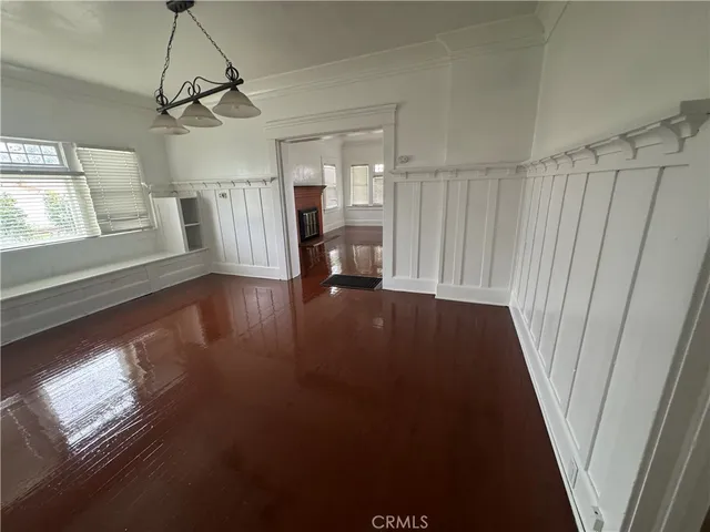 a view of empty room with window and fireplace
