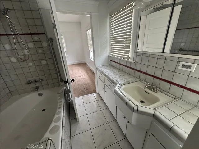 an empty room with windows and fireplace