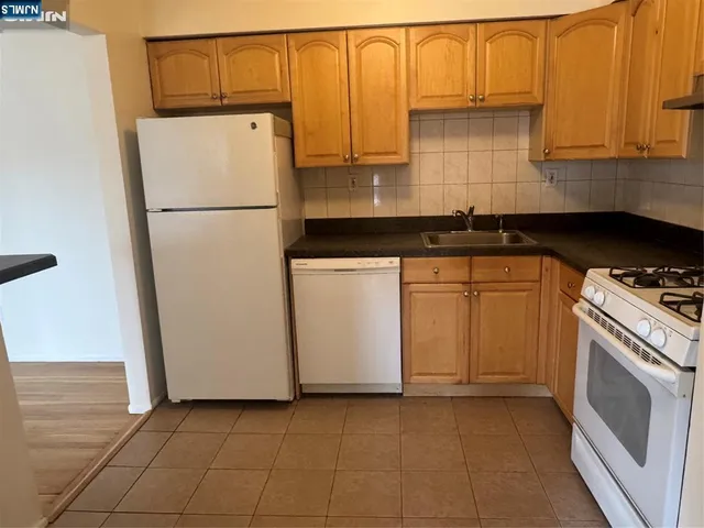 a kitchen with a sink a stove and a refrigerator