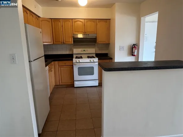 a kitchen with a stove and a refrigerator