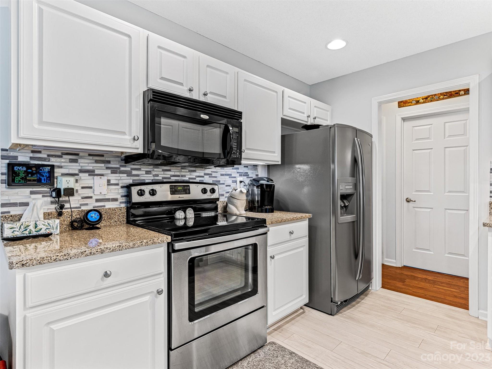 33 Black River Road Fletcher, NC 28732 - Photo 14 of 30 a kitchen with stainless steel appliances granite countertop a stove a refrigerator and a microwave