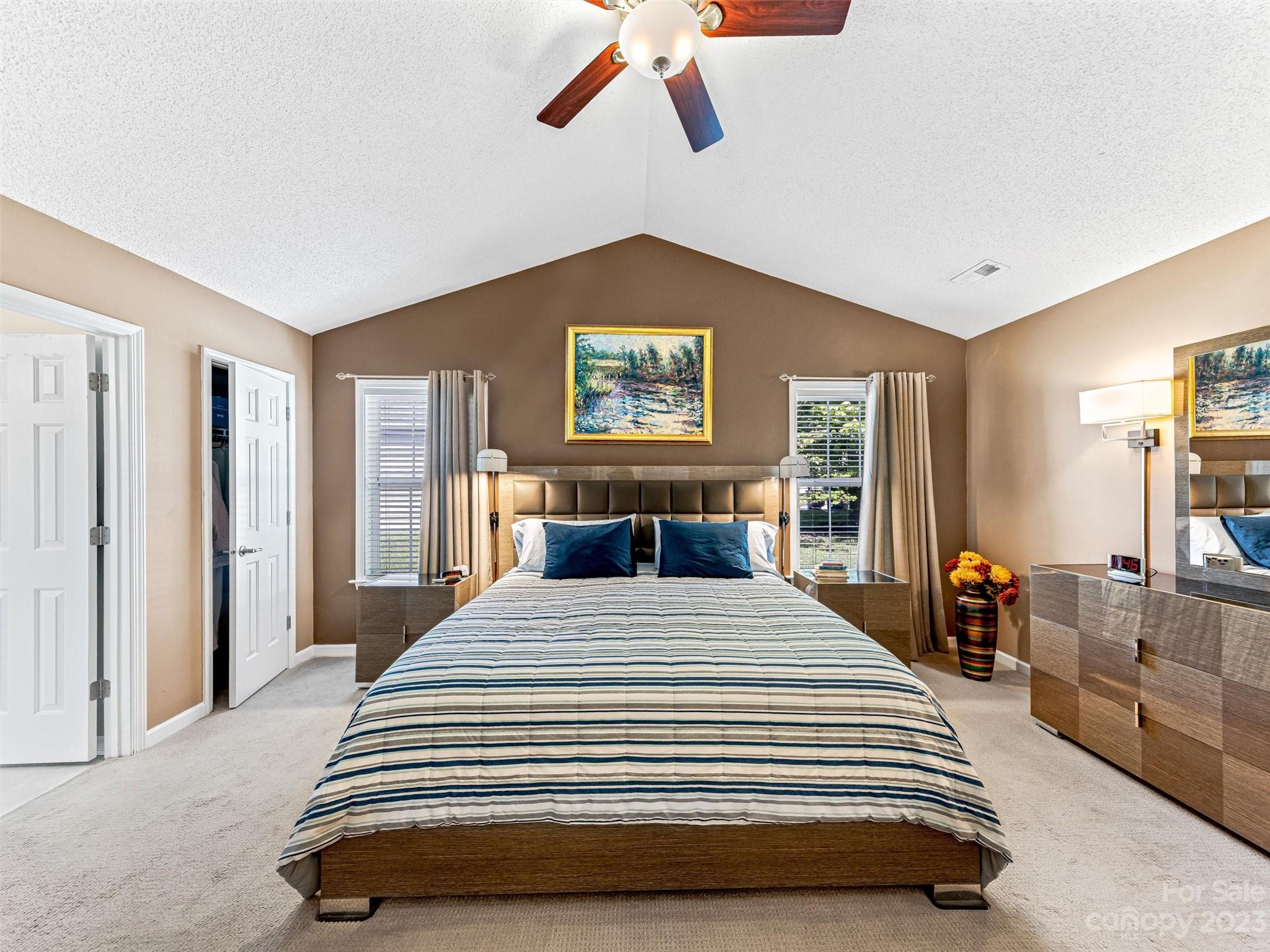 33 Black River Road Fletcher, NC 28732 - Photo 16 of 30 a bedroom with a large bed and a chandelier