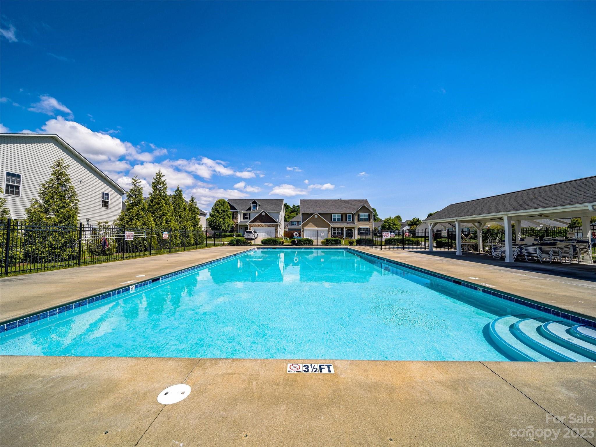 33 Black River Road Fletcher, NC 28732 - Photo 27 of 30 a view of a swimming pool with an outdoor seating and a garden