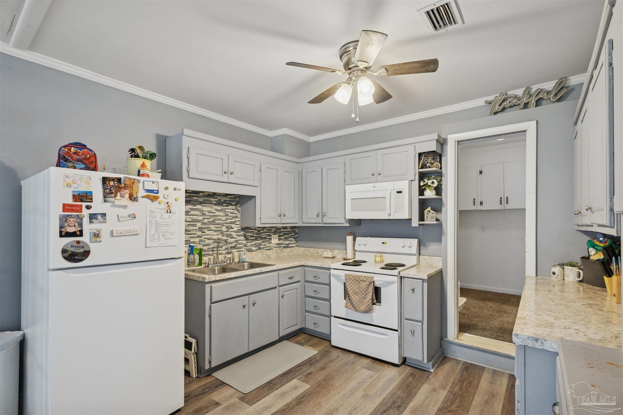 4176 Morristown Road Jay, FL 32565 - Photo 11 of 41 a kitchen with a stove a sink and a refrigerator