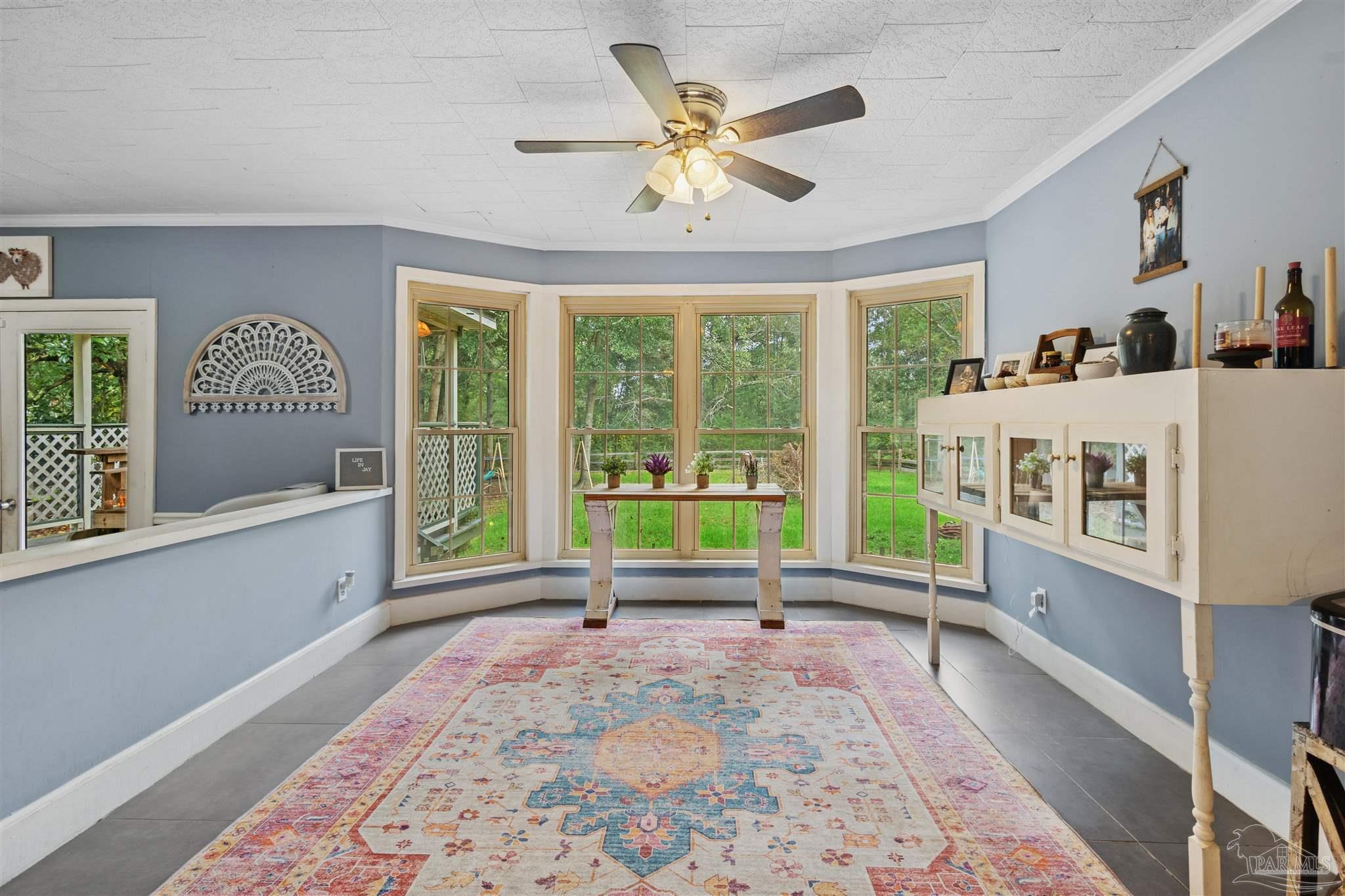 4176 Morristown Road Jay, FL 32565 - Photo 12 of 41 a living room with a baby crib furniture and a window