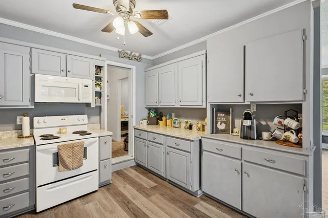 a kitchen with stainless steel appliances white cabinets and a sink