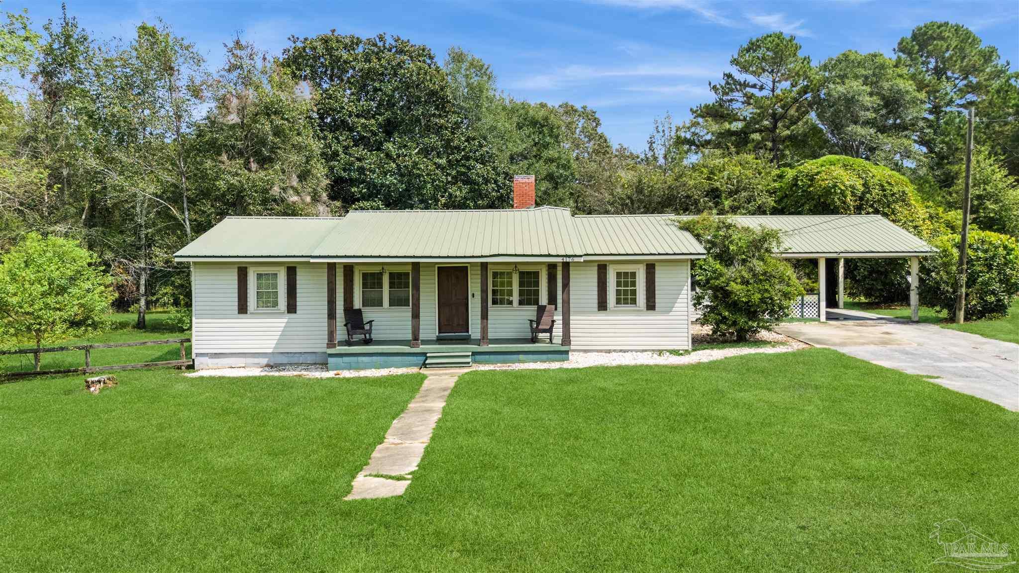 4176 Morristown Road Jay, FL 32565 - Photo 2 of 41 a front view of a house with a yard porch and furniture