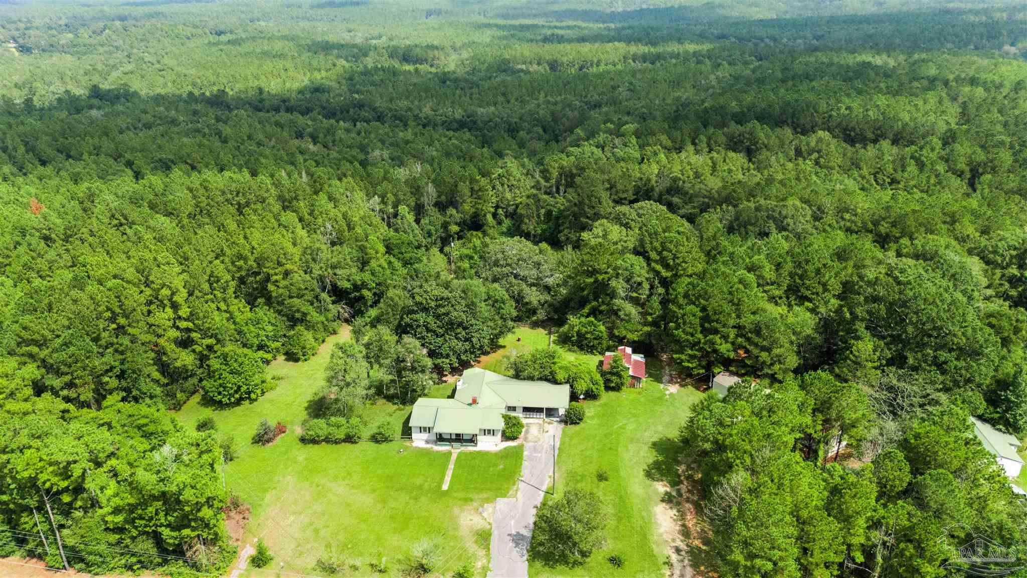 4176 Morristown Road Jay, FL 32565 - Photo 36 of 41 a view of a garden with a building in a yard