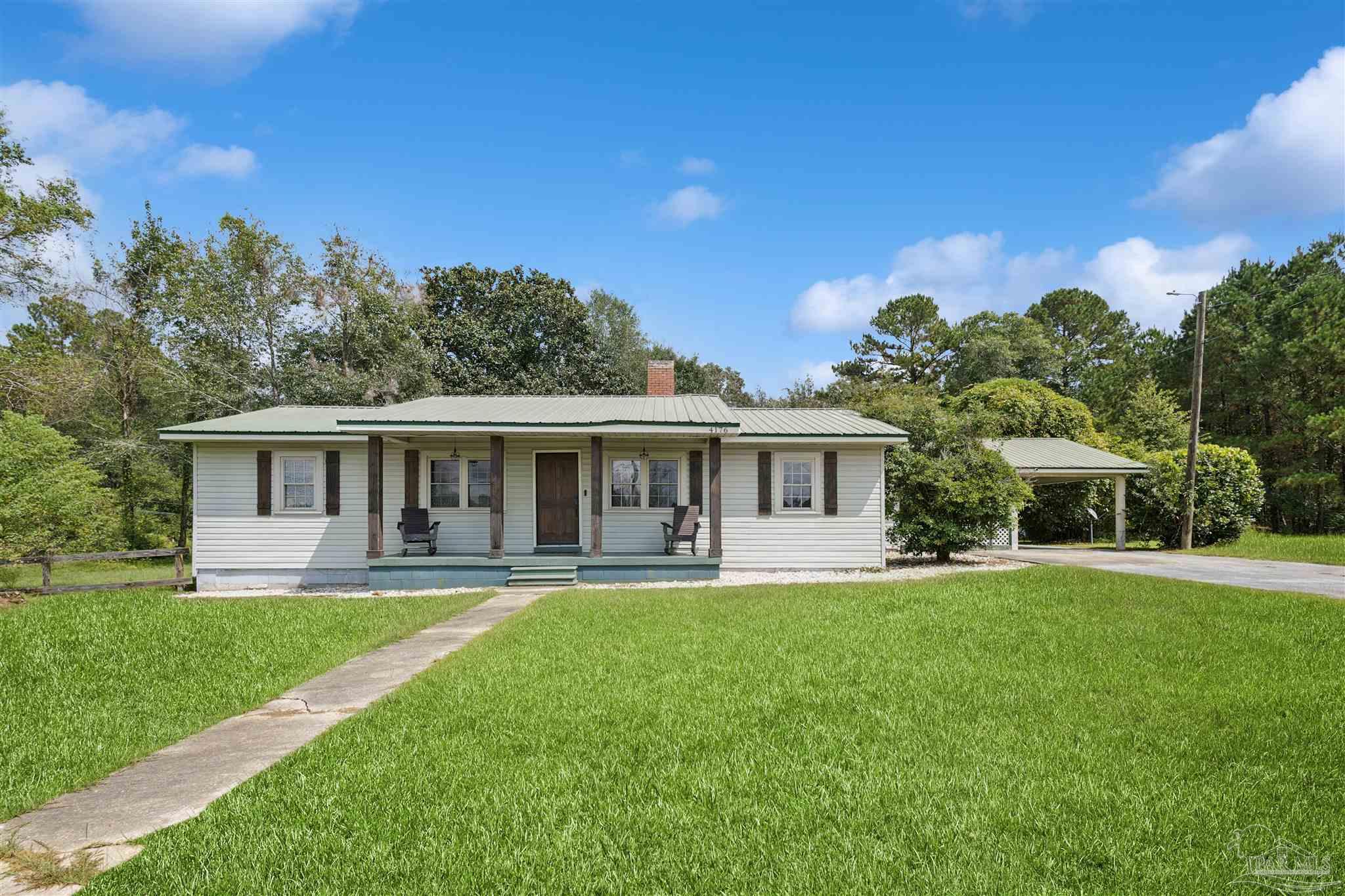 4176 Morristown Road Jay, FL 32565 - Photo 40 of 41 a front view of house with a garden