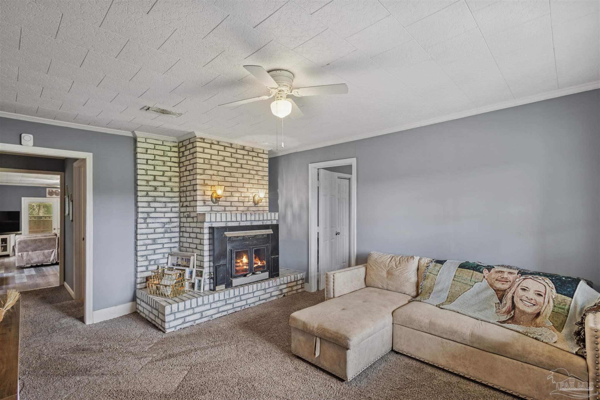 4176 Morristown Road Jay, FL 32565 - Photo 4 of 41 a living room with furniture and a fireplace