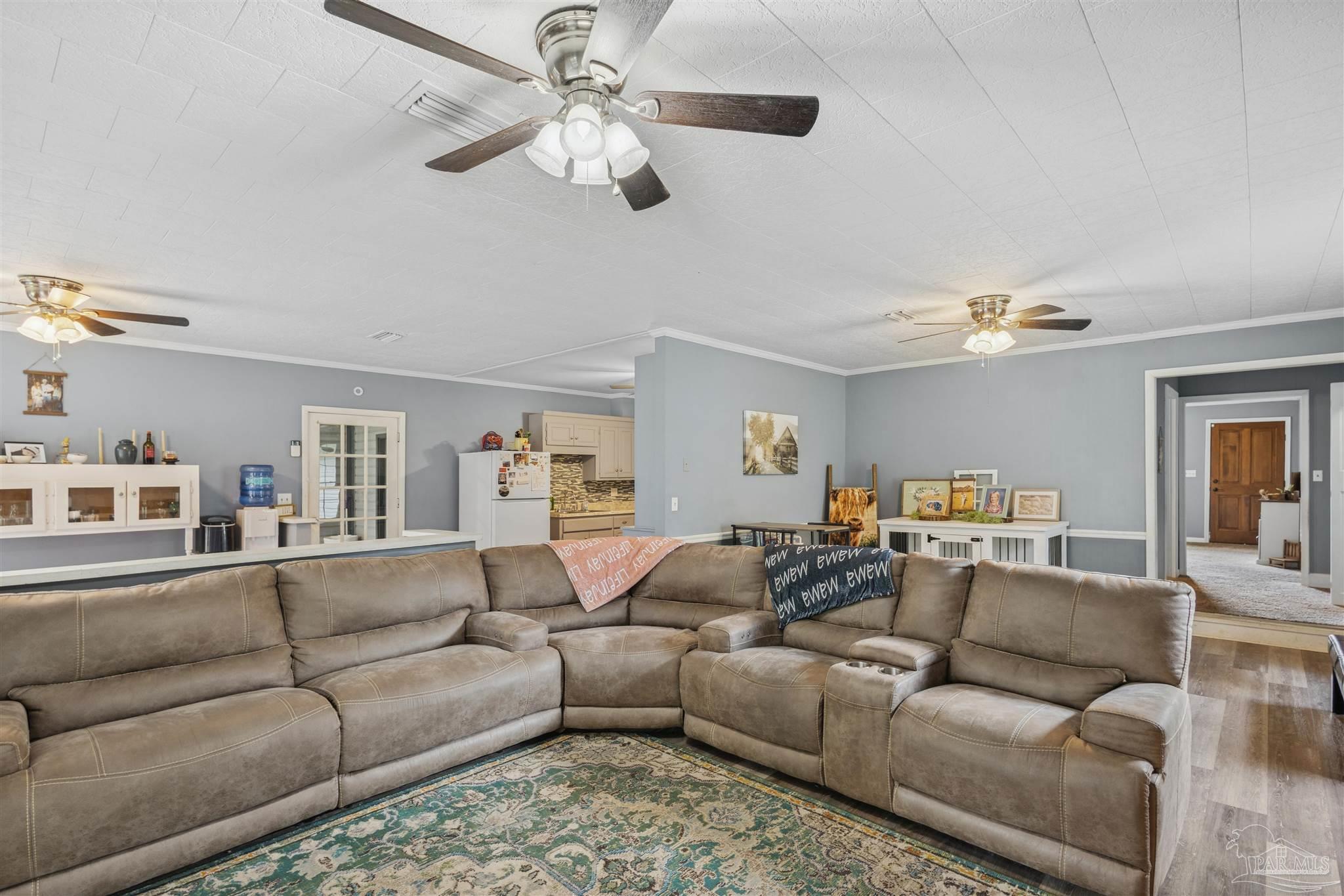 4176 Morristown Road Jay, FL 32565 - Photo 10 of 41 a living room with furniture ceiling fan and a rug